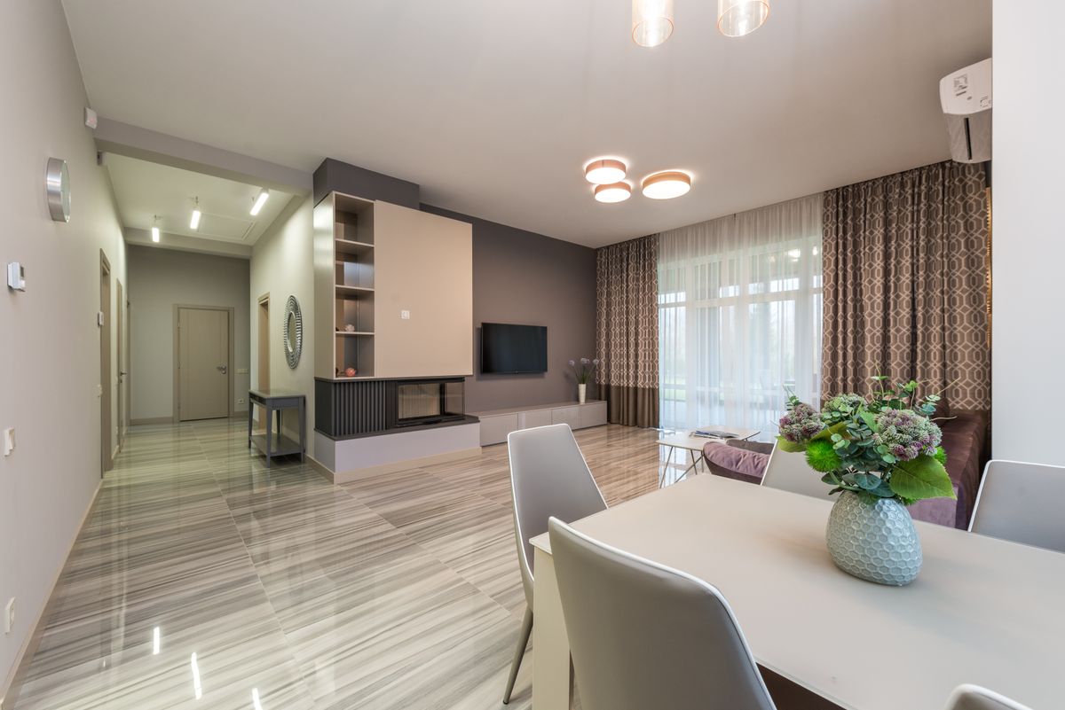 A dining table and living area sharing an open apartment room.