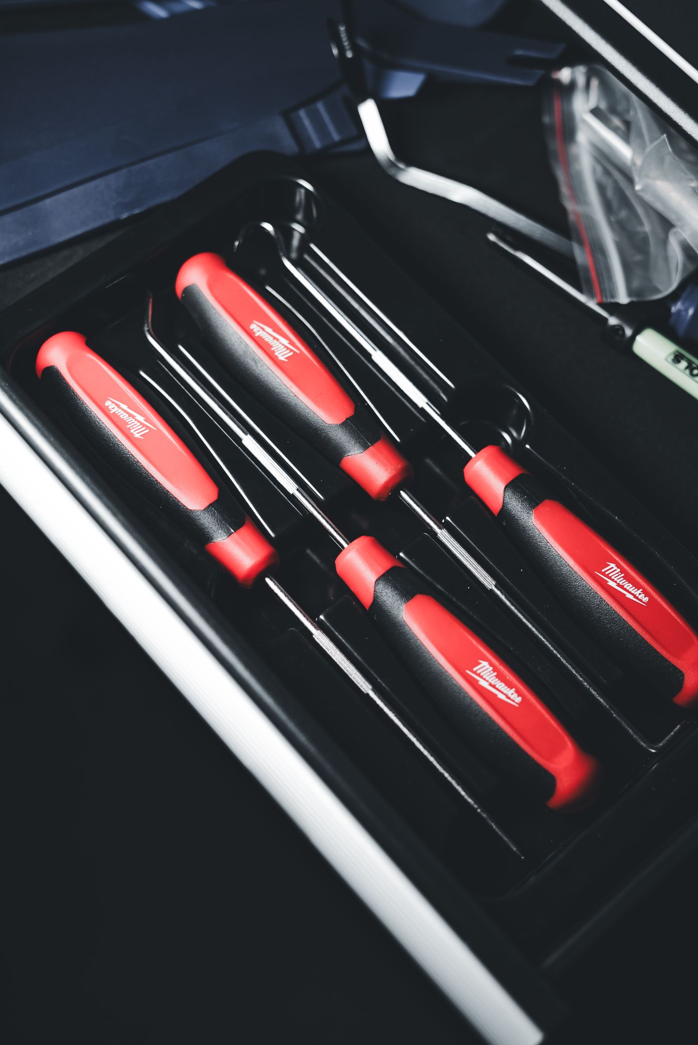 Screwdrivers arranged in a red and black toolbox