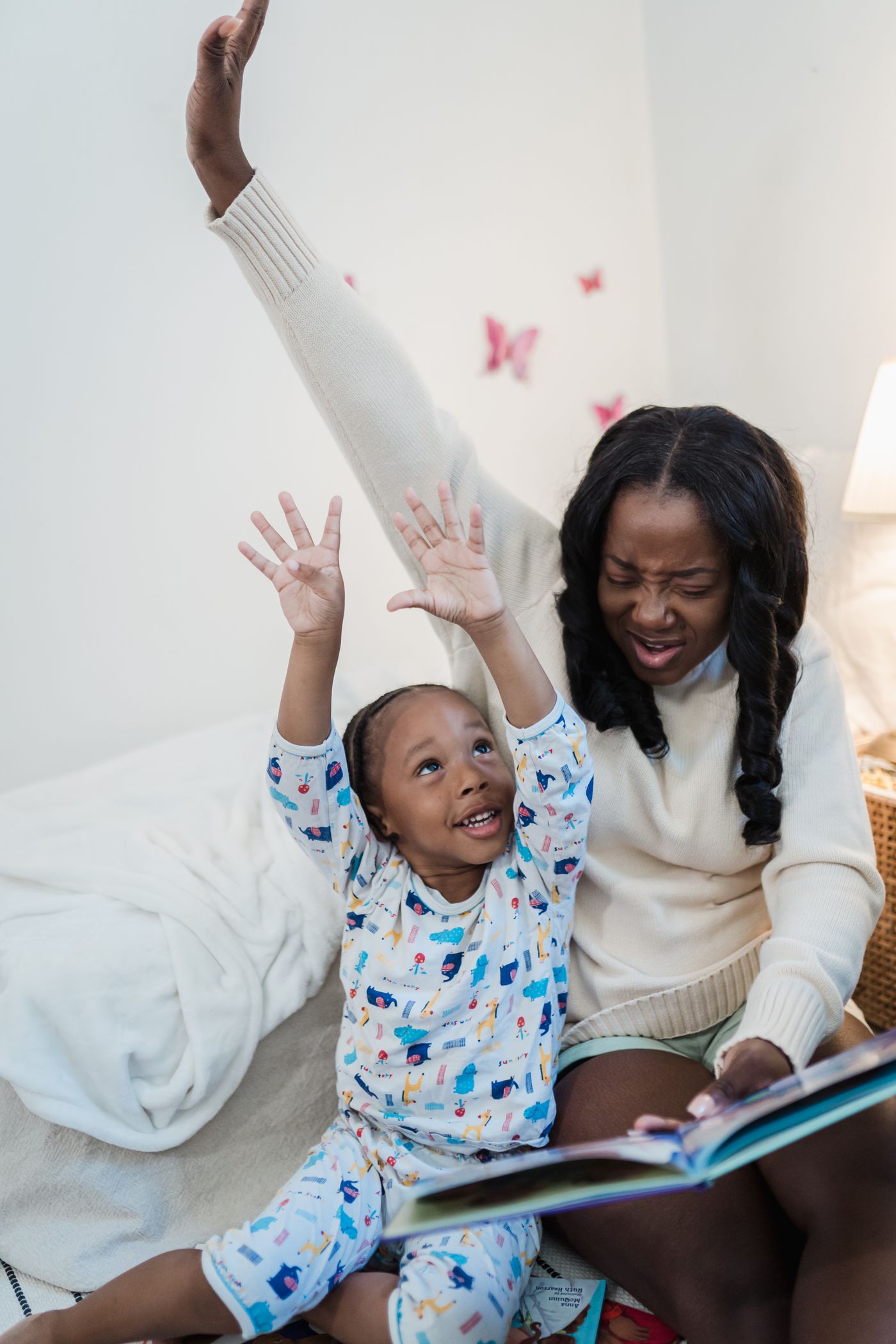 A parent reading with a child in bed
