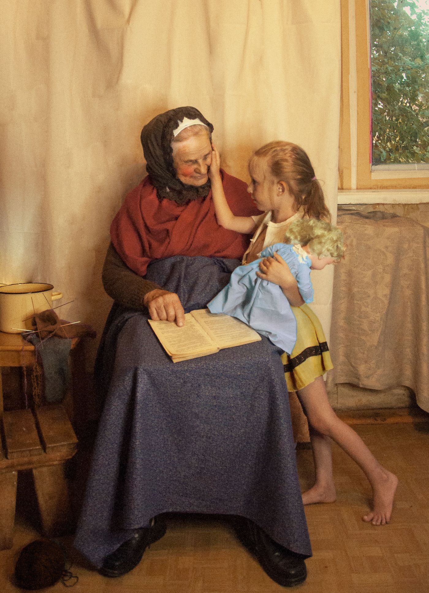 A child and grandmother sitting together at home