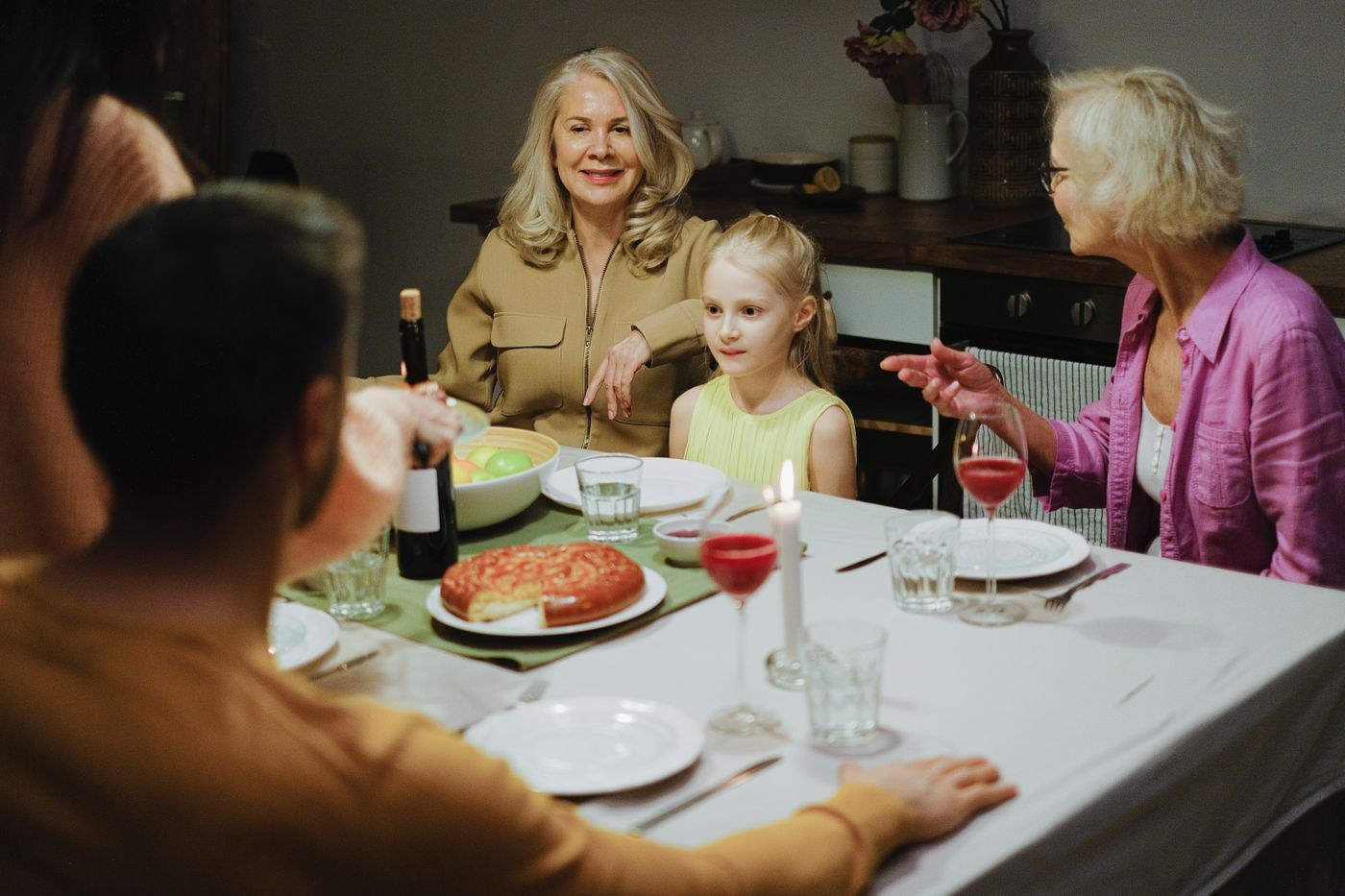 Adults and children sharing a meal around a table