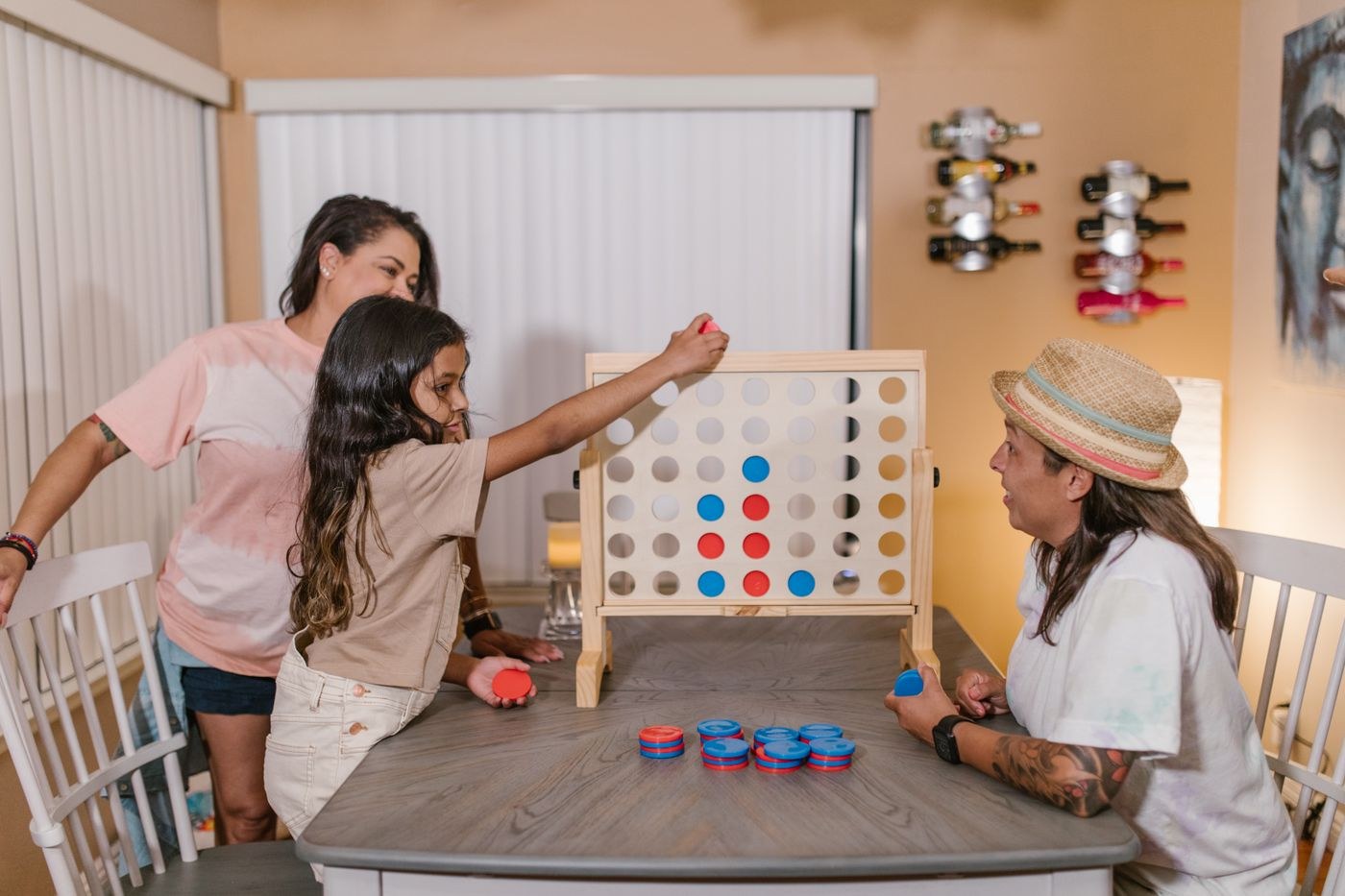 Adults and children playing a tabletop game