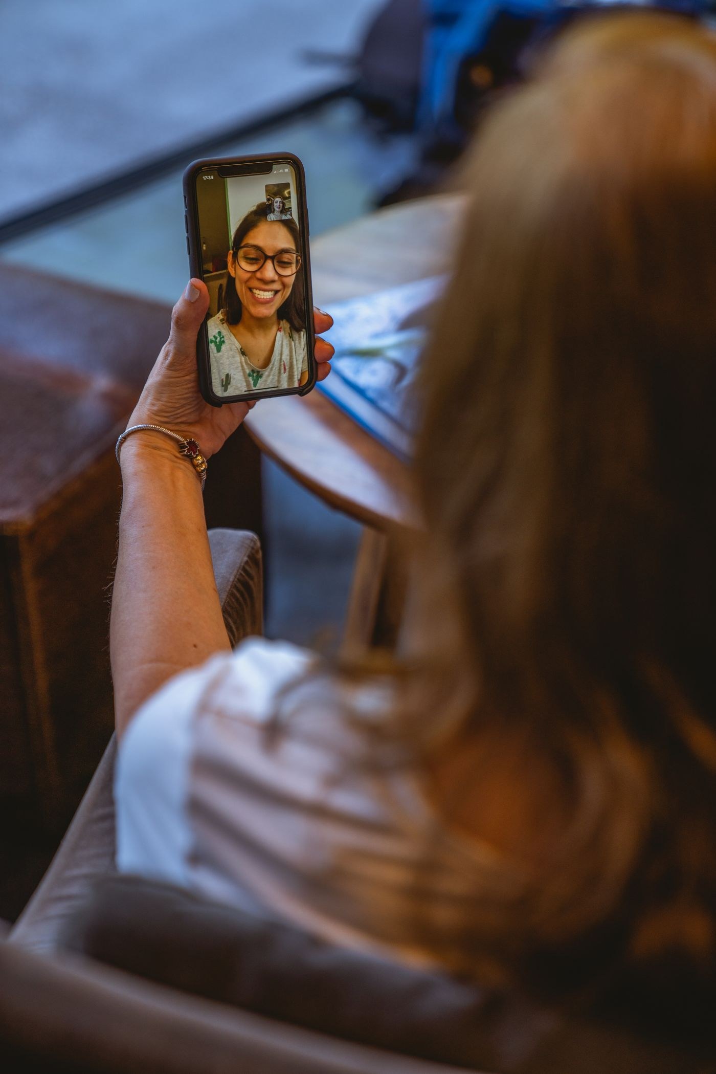 A woman holding a phone during a video call